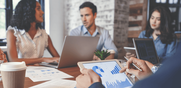coworkers sitting around a table in a marketing meeting