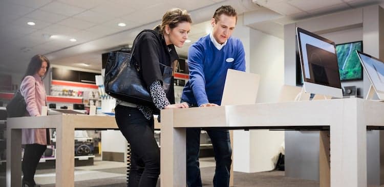 person helping with tech support in a store