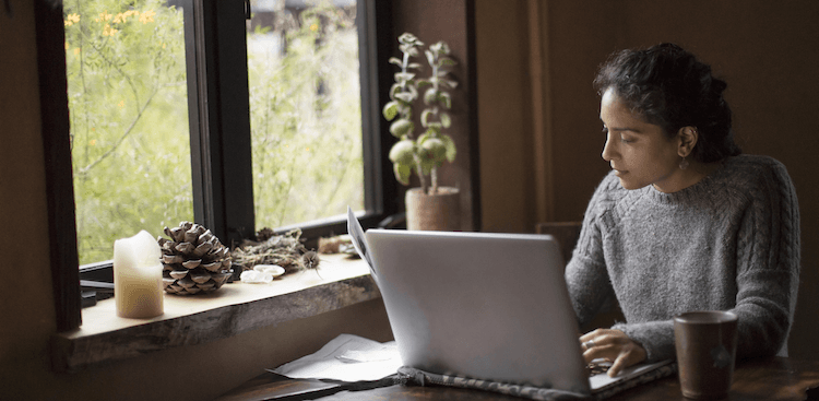 person sitting at a desk working on a laptop
