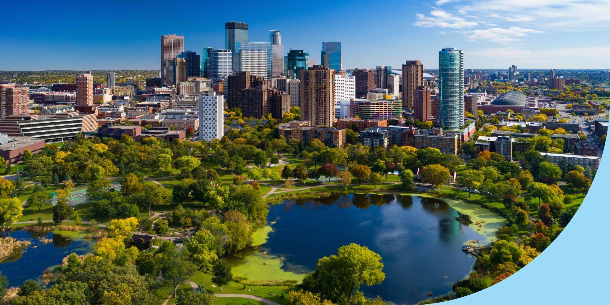 Minneapolis aerial with Downtown Minneapolis skyline in the background and Loring Park with Loring Pond in the foreground, during early autumn