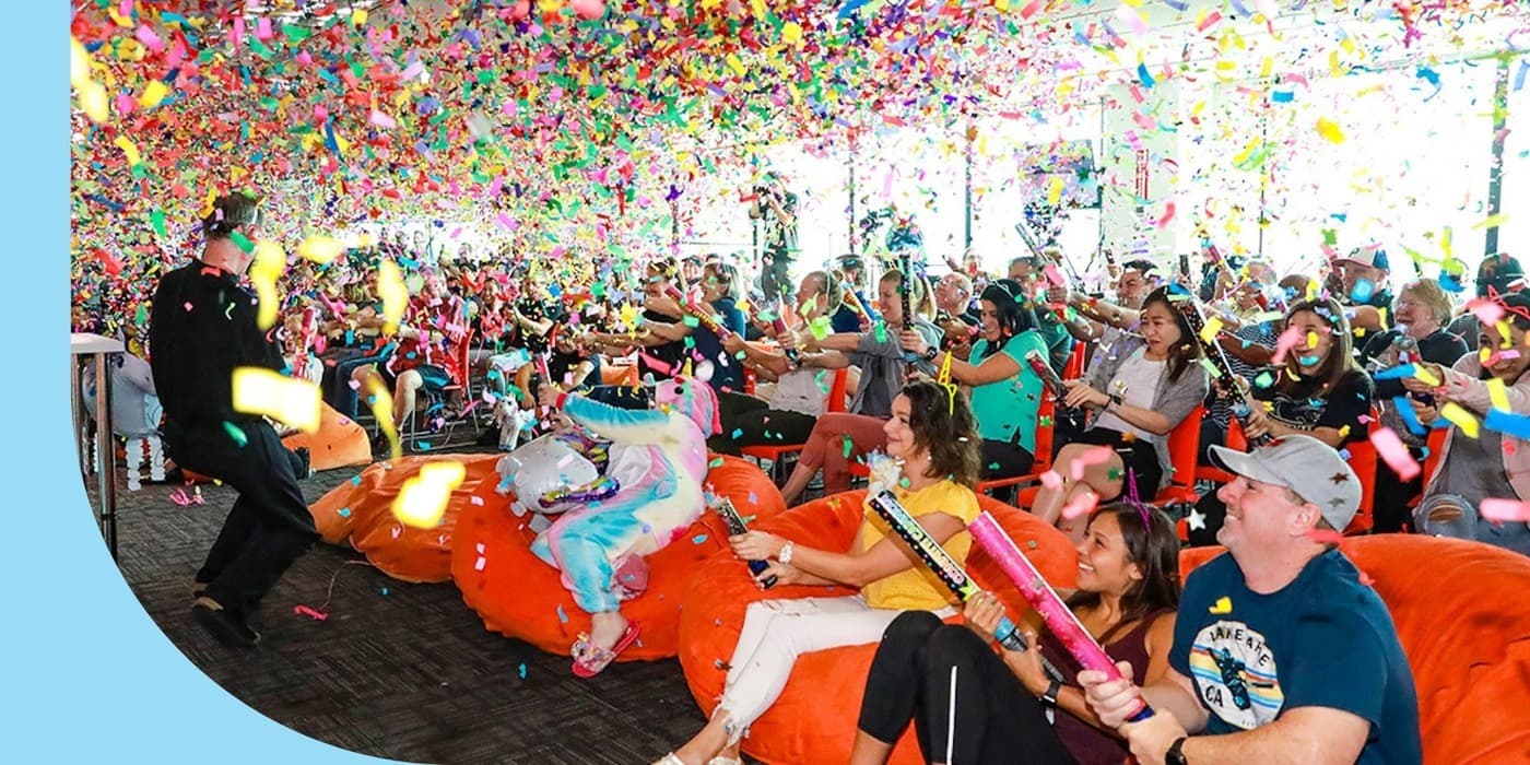 KnowBe4 employees celebrating in the office with confetti.